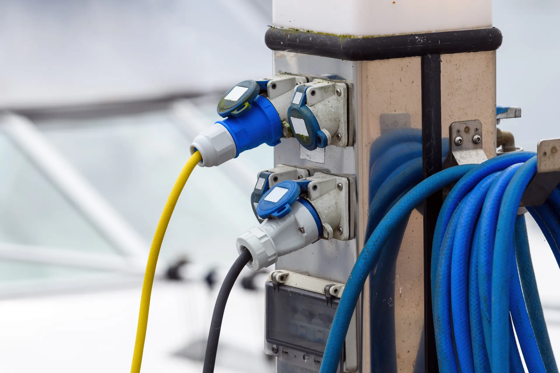 Shore power pedestal with marina charging connectors on a Thames pontoon