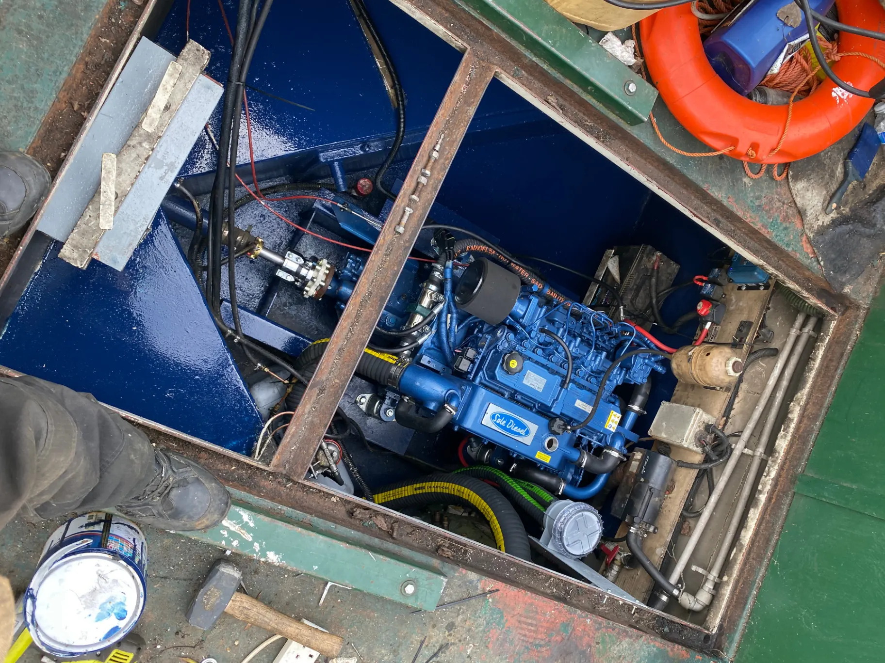 Marine engineer working on a boat engine at the dockside